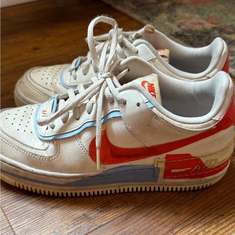 Nike White Air Force Ones with Orange and Blue swoosh